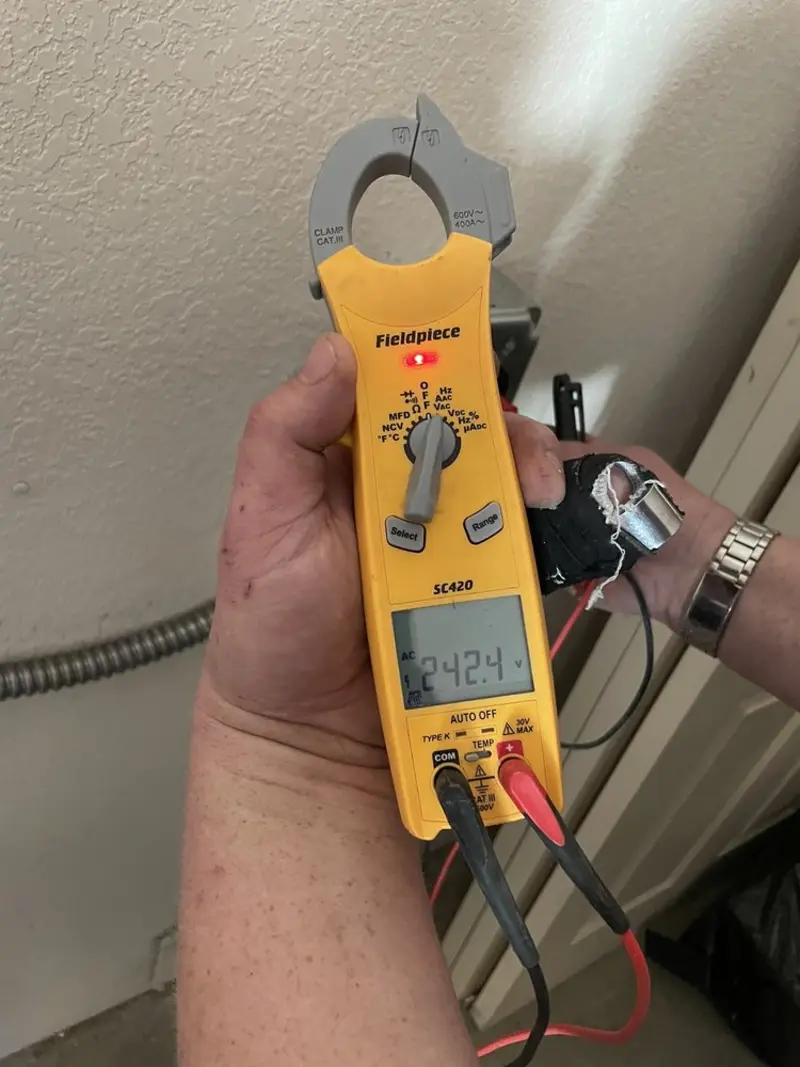 Voltage testing with clamp meter during Whole House Surge Protector in West Orange